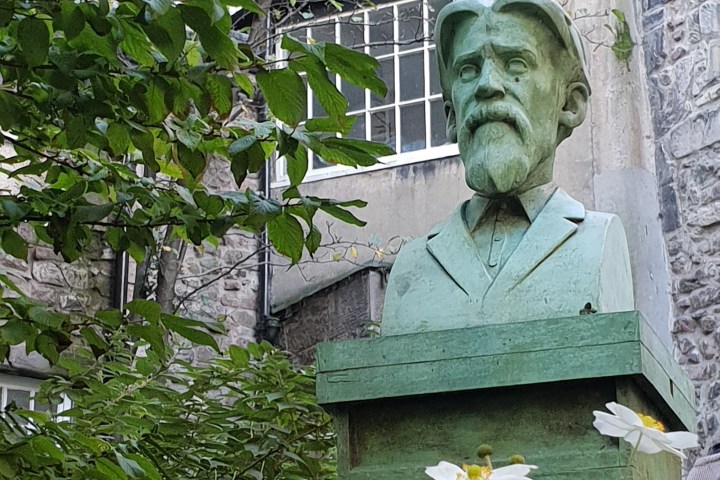 a person sitting in front of a brick building