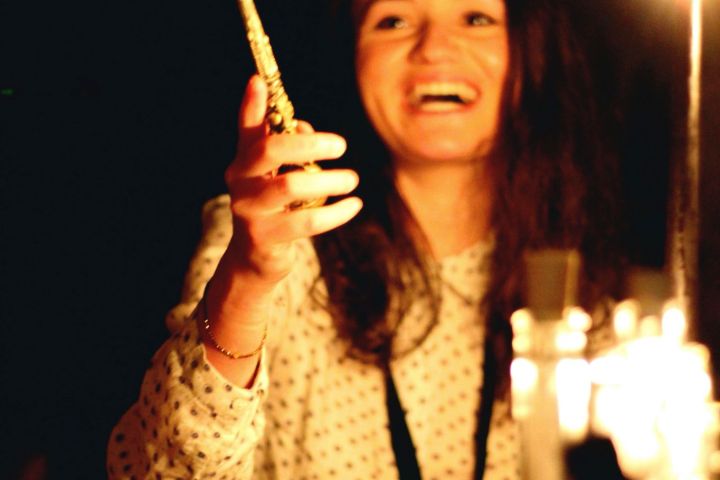 a woman standing in front of a fire
