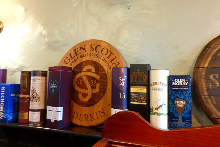 a bottle of beer next to a book