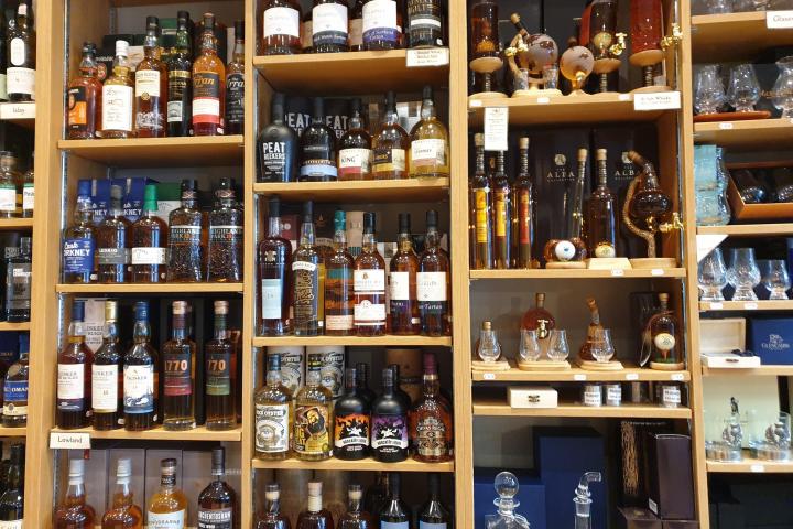 a store shelf filled with scotch glasses