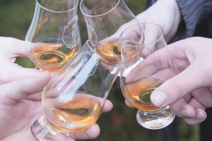 a hand holding a glass of wine