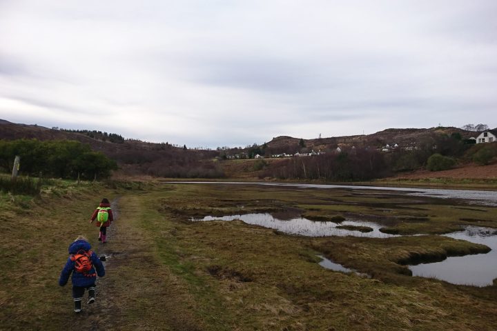 a man riding a motorcycle down a dirt road