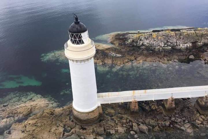 a close up of a rock next to a body of water