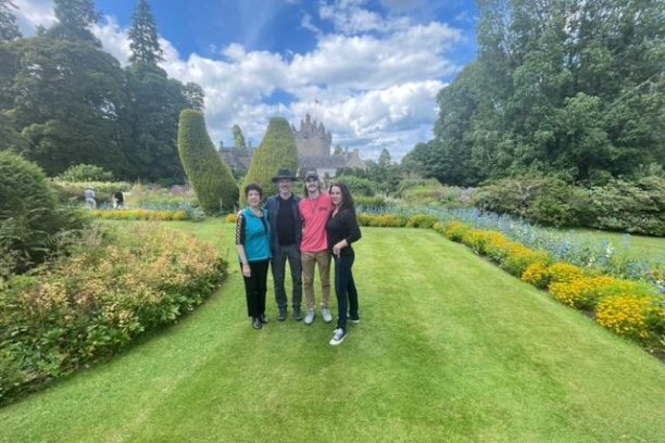 a couple of people that are standing in the grass