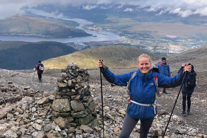 a group of people standing on a rocky hill