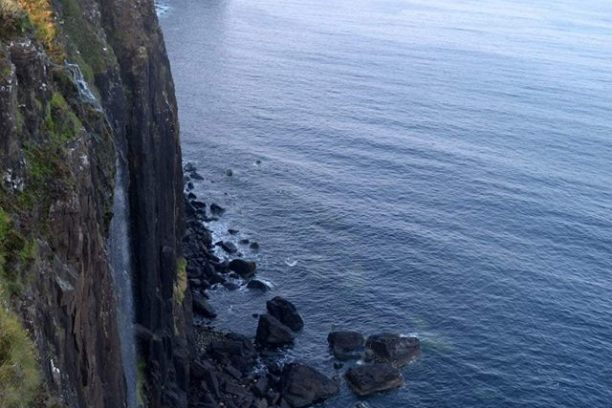 a rocky island in the middle of a body of water