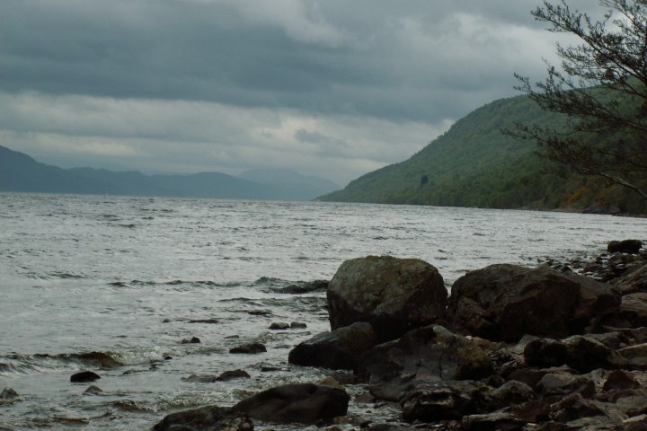 a body of water with a mountain in the background