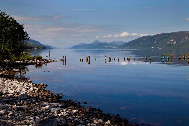 a large body of water with a mountain in the background