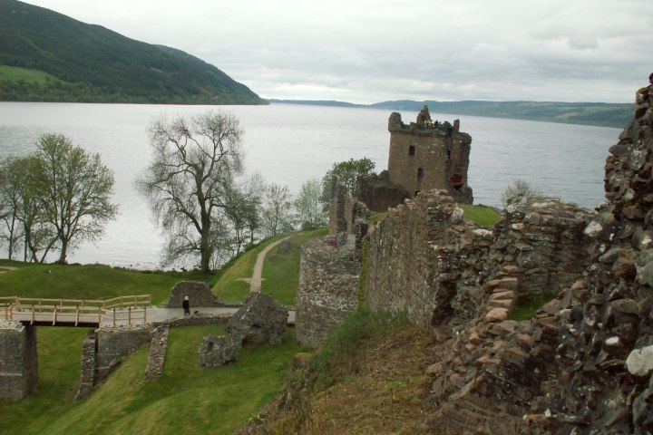 a castle on a hill overlooking a body of water