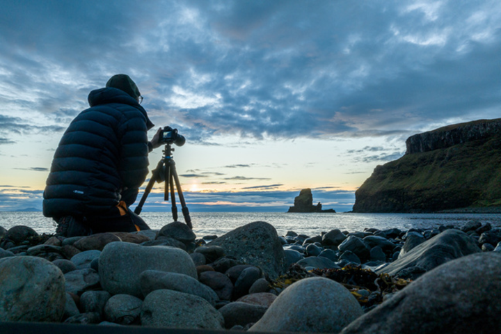 a rocky beach next to a body of water
