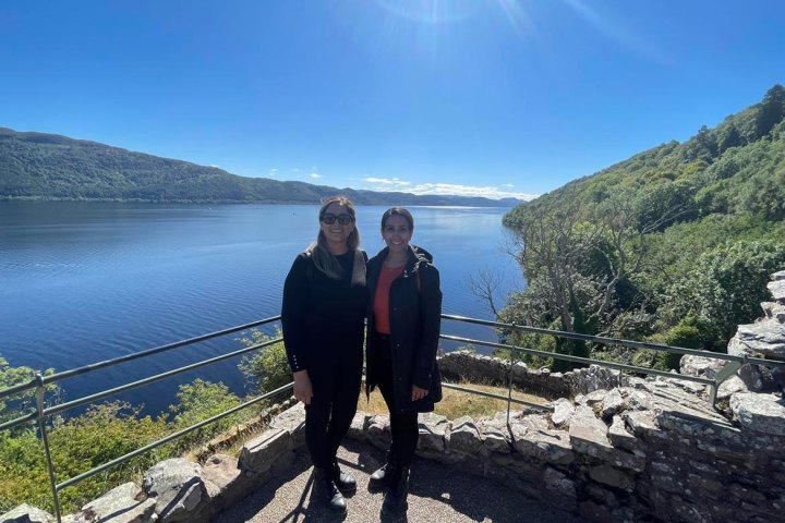 a man standing next to a body of water