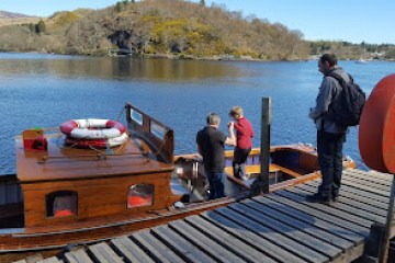 a group of people standing next to a body of water