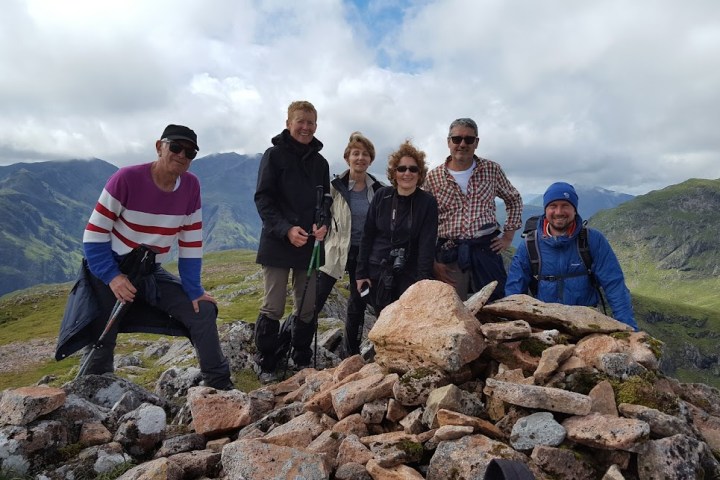 a group of people standing on a rock