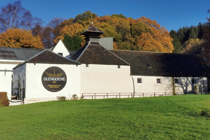 a house that has a sign on a grassy field