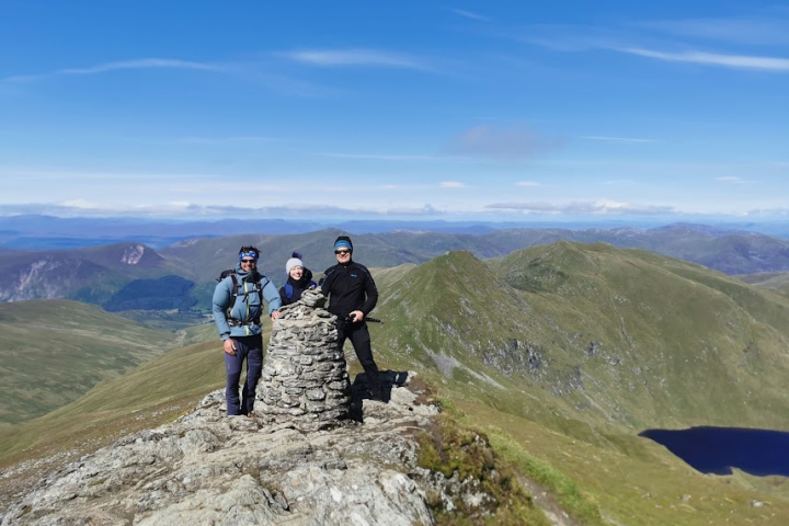 a group of people standing on top of a mountain