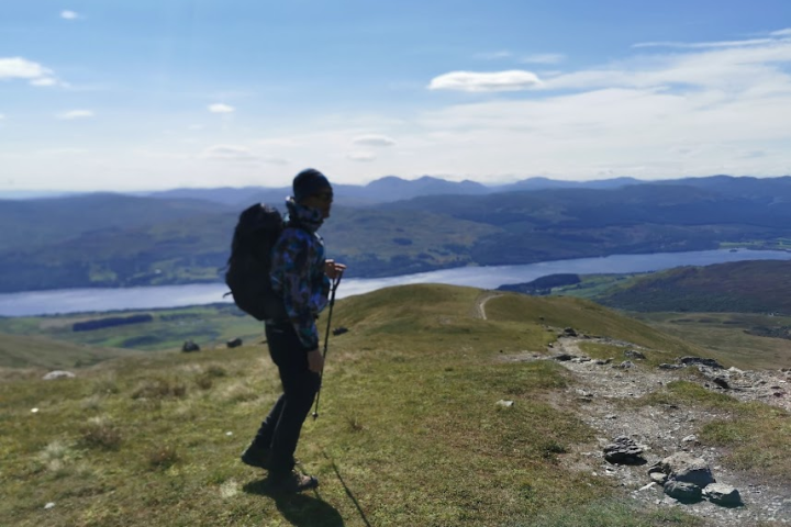 a man standing on top of a hill
