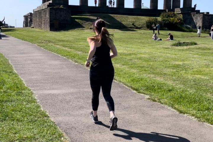a young boy riding a skateboard up the side of a road