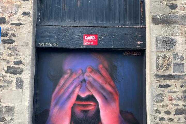 a person standing in front of a brick building