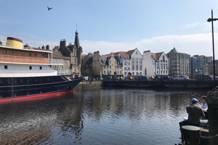 a boat in the water with a city in the background