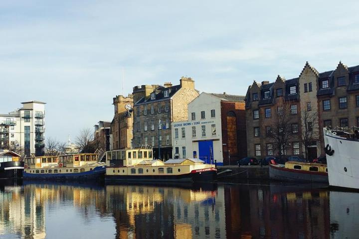 a body of water with a city in the background