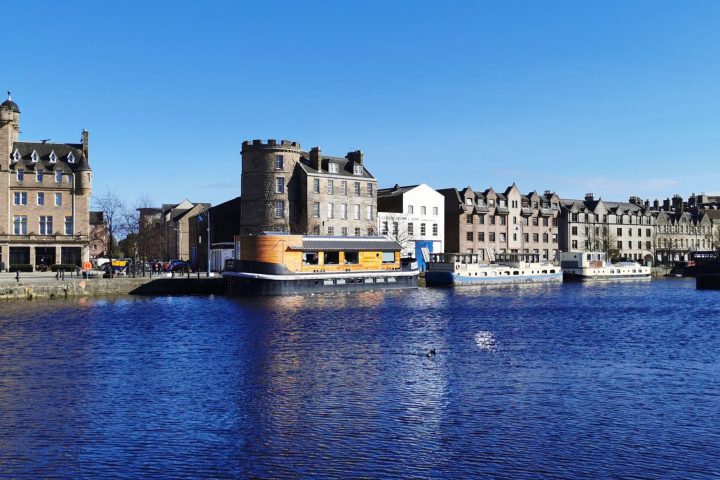 a large body of water with a city in the background