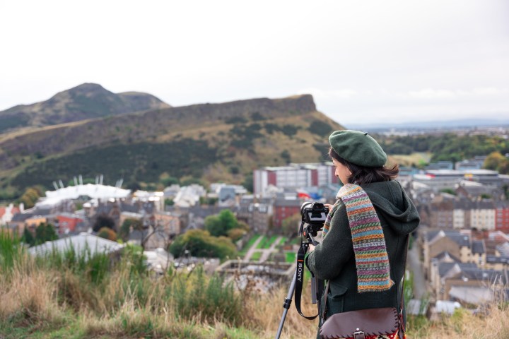 a person standing in front of a mountain