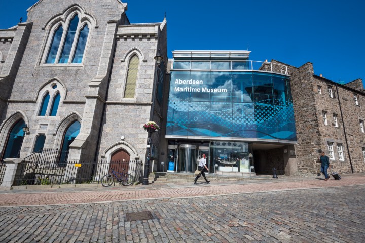 Aberdeen Maritime Museum with stone facade and modern glass extension on a sunny day.