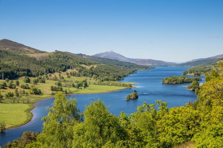 a body of water with a mountain in the background