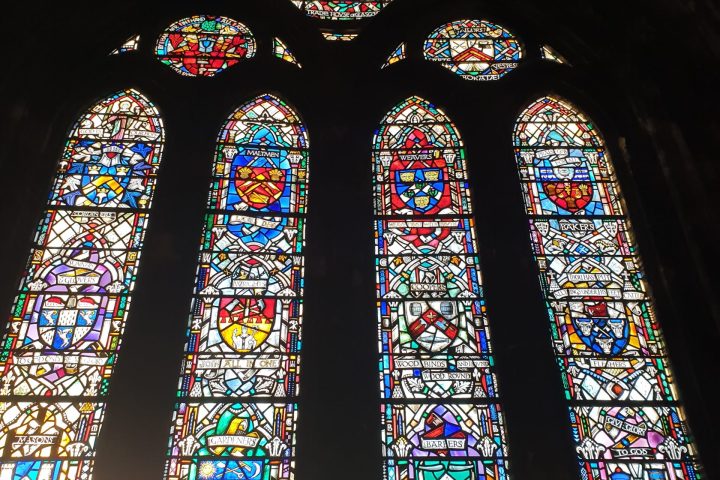 a group of people performing on stage in front of a window