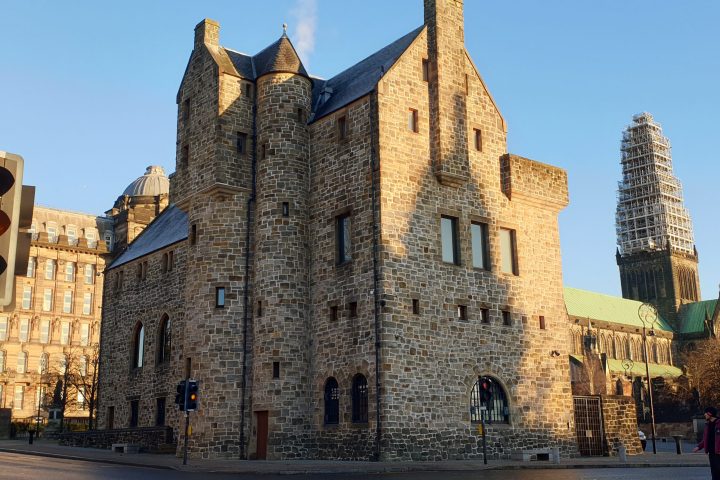 a castle on top of a stone building with St Mungo Museum of Religious Life and Art in the background