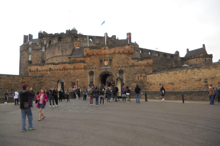 a group of people walking in front of Edinburgh Castle