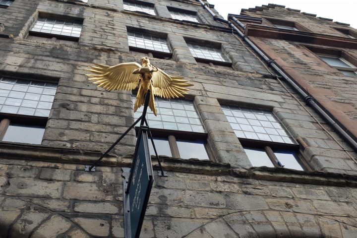 a large brick tower with a clock on the side of a building
