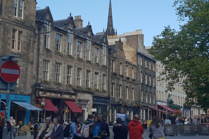 a group of people walking in front of a building