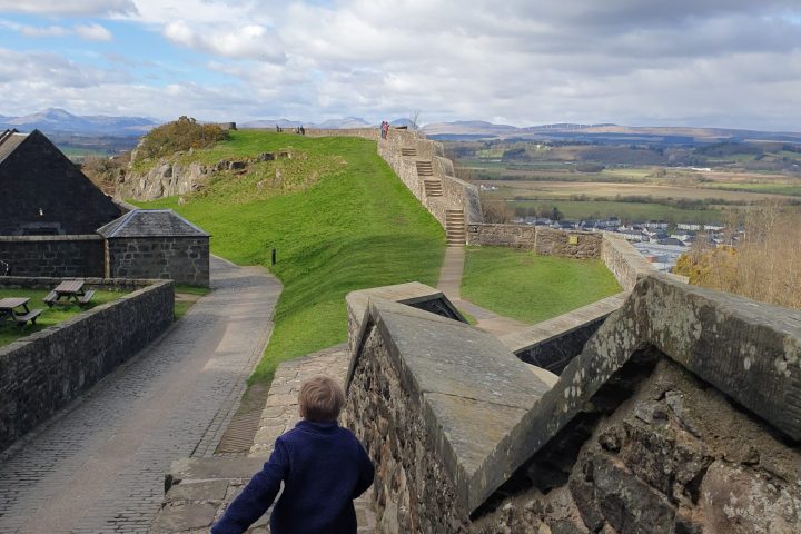 a stone building that has a rock wall
