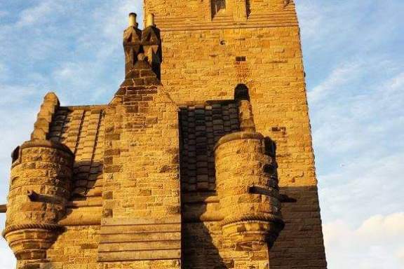 a person standing in front of a brick building