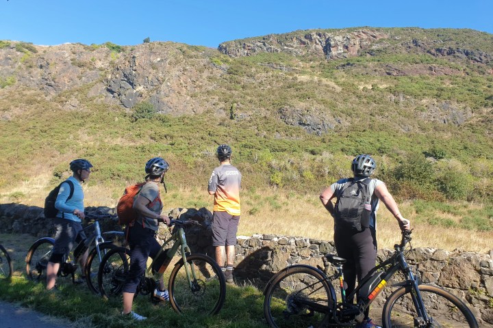 a group of people riding on the back of a bicycle