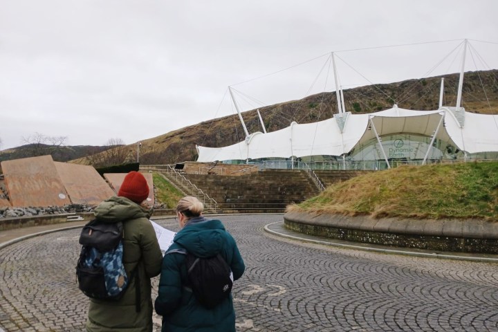 a group of people walking on a bridge